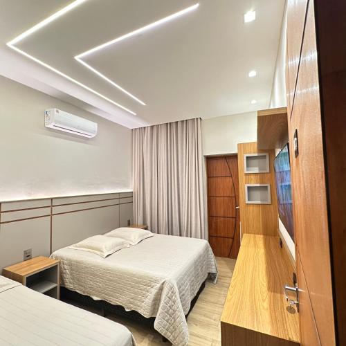 a hotel room with two beds and a room with at Pousada das Águas in Lambari