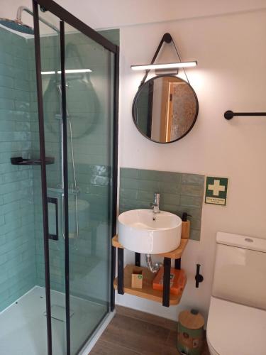 a bathroom with a sink and a glass shower at Quinta Pedra do Rio - Tâmega in Salvador do Monte