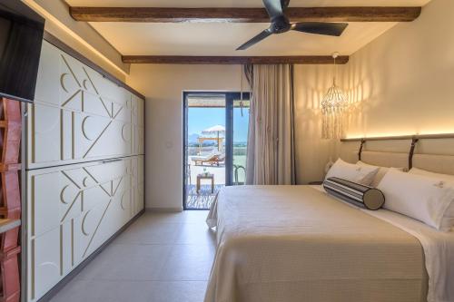 a bedroom with a bed and a balcony at Zefyria Luxury Suites in Zefiría