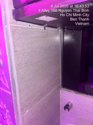 a bathroom with a mirror and a pink wall at Snal Spare Hotel in Ho Chi Minh City