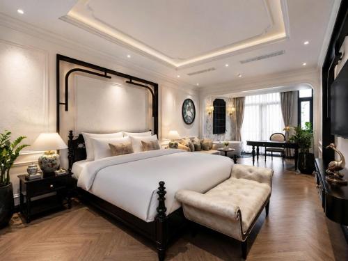a large bedroom with a large bed and a couch at Snal Spare Hotel in Ho Chi Minh City