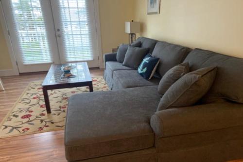 a living room with a couch and a coffee table at New Riverfront Condo in Sheepscot Harbour - Walk to Famed Seafood Eatery in Edgecomb