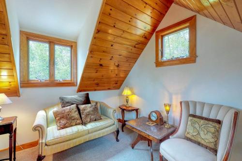 a living room with a couch and a chair at Beautiful hilltop home with deck & view of Penobscot Bay - near festivals & more in Rockport