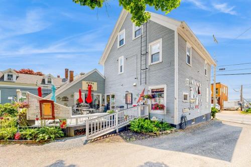 a large gray house with a white porch at Nautical vacation rental in in walkable downtown with harbor view, grill & deck in Boothbay Harbor