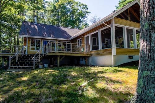a home with a large porch and a large deck at Private waterfront home with large deck & deep water dock in Georgetown