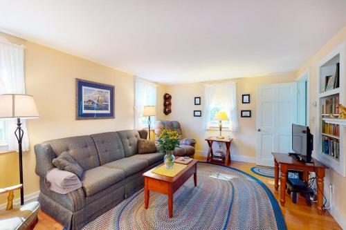 a living room with a couch and a table at Comfortable home near the beach - dog-friendly - full kitchen & washer/dryer in Rockland