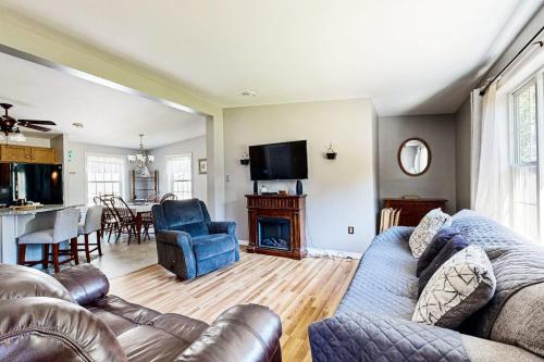 a living room with a couch and a fireplace at Charming cottage near the beach with balcony, deck, grill, fireplace - dogs OK in Georgetown