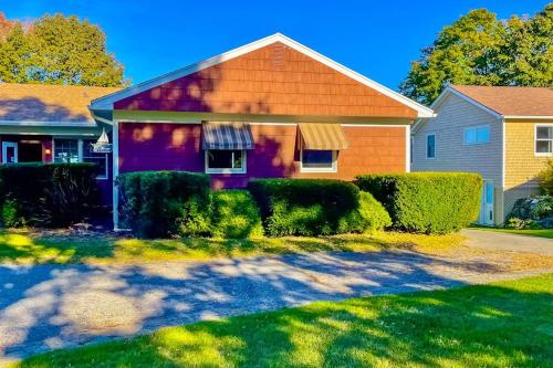 a house with bushes in front of it at Waterfront home with beautiful bay views - near shops & dining in Owls Head
