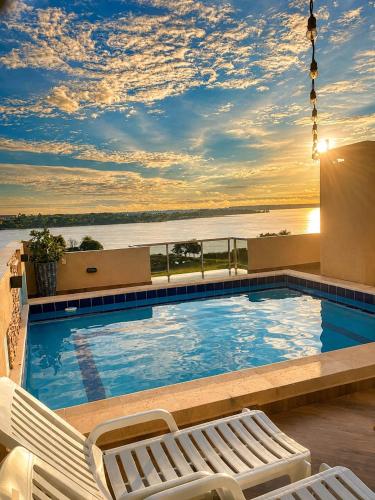 a swimming pool with a view of the water at Hotel Diromani in Hernandarias