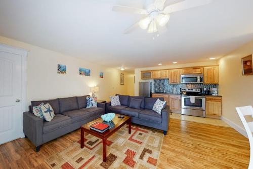 a living room with a couch and a table at Stylish Condo at Sheepscot Harbor Resort w/Free WiFi, River Views, & Balcony in Edgecomb