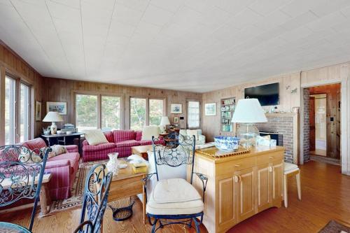 a living room with a couch and a table at Beachfront Delight with detached guesthouse, private beach access, Dog-friendly in Southport