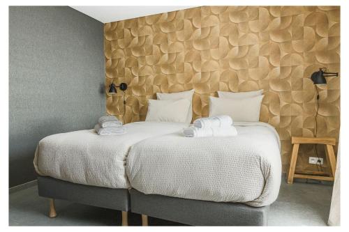 a bedroom with two beds with white sheets at L'Aurore Céleste in Aywaille