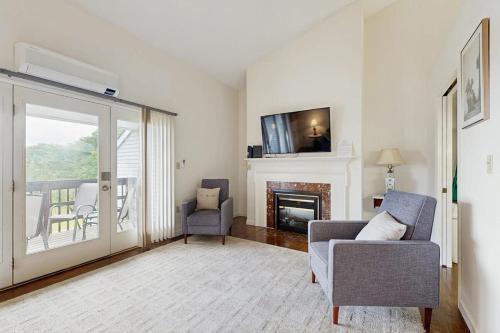 a living room with a couch and a fireplace at Dog-Friendly Townhouse w/Bay Views, Fast WiFi, and Partial A/C in Bar Harbor