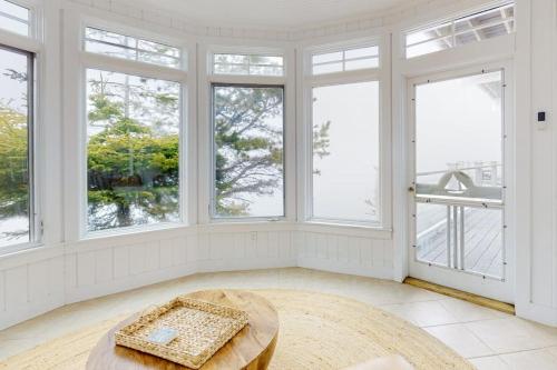 a large room with windows and a table at Spectacular oceanfront retreat with amazing views, sunroom & washer/dryer in Georgetown