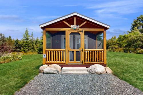 a small cabin in a field with some rocks at Cozy Cabin with Ocean and Mountain Views, Free Internet in Sullivan