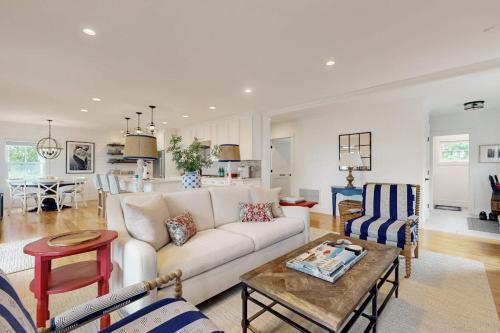a living room with a couch and a table at Elegant home with veranda & water view, walk to downtown Boothbay Harbor in Boothbay Harbor
