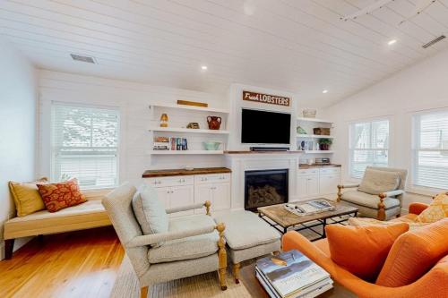 a living room with a fireplace and a tv at Perfectly Located Retreat with Grill, Fireplace, & Chef in Boothbay Harbor