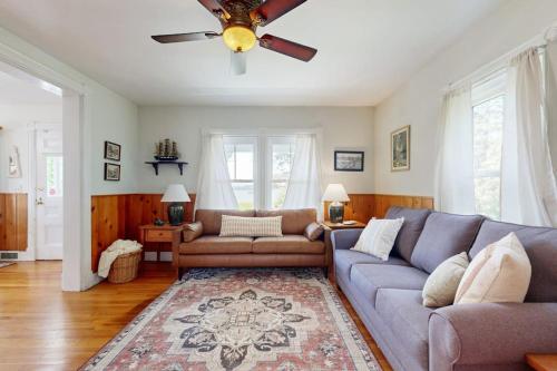 a living room with a couch and a ceiling fan at Coastal Serenity Retreat with Ocean Views, Spacious Porch and Modern Comforts in Sullivan