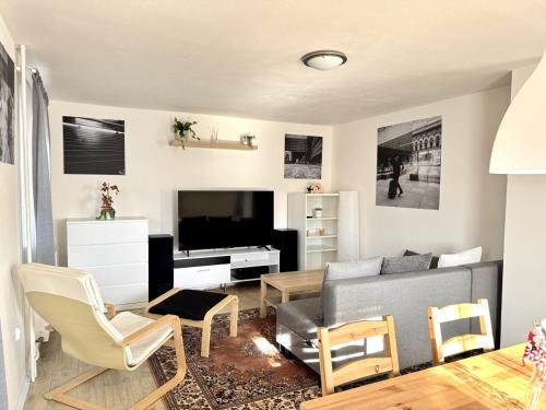 a living room with a couch and a tv at Cozy Family Retreat in a Quiet Village in Křešín