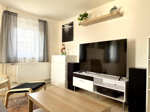 a living room with a large flat screen tv at Cozy Family Retreat in a Quiet Village in Křešín