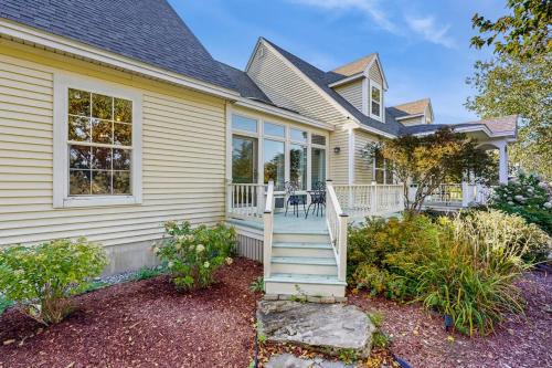 a white house with a porch and stairs at Newly Renovated Charming House with Cozy Fireplace & Outdoor Entertainment Areas in Rockport