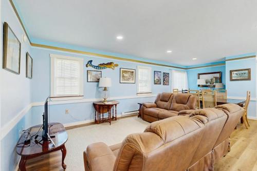 a living room with two couches and a tv at Charming, single-level getaway with a full kitchen, fast WiFi, & grassy yard in Boothbay