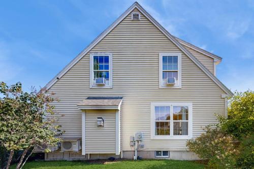 a large white house with a gambrel at Newly Renovated Charming House with Cozy Fireplace & Outdoor Entertainment Areas in Rockport