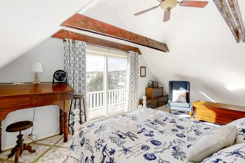 a bedroom with a large bed and a window at Oceanfront house with dock, kayaks, deck, and gas grill in Boothbay Harbor