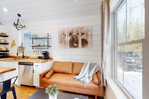 a living room with a couch in a kitchen at Brand-new dog-friendly home near Hancock Pond with firepit, grill, streaming, AC in Bucksport