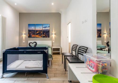 a room with a bed and a table and chairs at Moon Bologna in Bologna