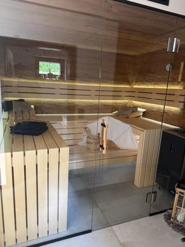 a wooden room with a bed and a desk at Secret Garden Spa House - Pool & Sauna in Großenlüder