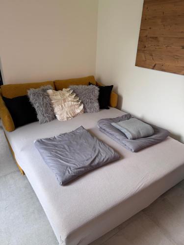 a bed with two pillows on it in a room at Secret Garden Spa House - Pool & Sauna in Großenlüder