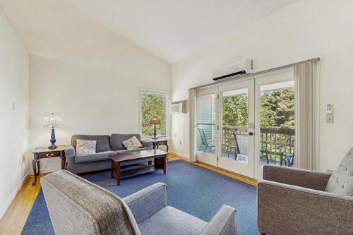 a living room with a couch and a table at Family & Dog-Friendly Townhouse w/Back Porch, Views, Partial AC in Bar Harbor