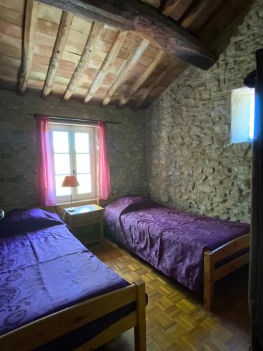 a bedroom with two beds and a window at Maison des lavandes in Apt