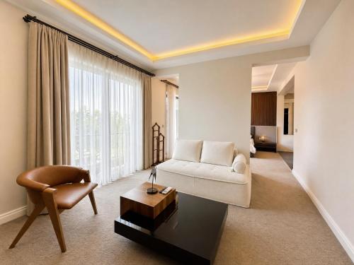 a living room with a couch and a chair at Didi Hotel Sapanca in Sapanca