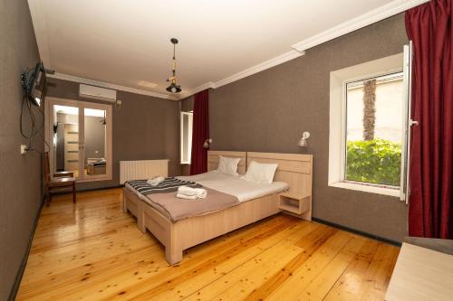 a bedroom with a bed and a window at Varga Kvareli in Kvareli