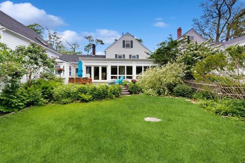 a large white house with a large yard at Elegant Historic Home with Refined Interiors and Private Outdoor Spaces in Camden