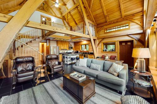 a living room with a couch and chairs in a cabin at The Cabin on 32 wooded acres - tranquil new-build with sauna & forested views in Franklin