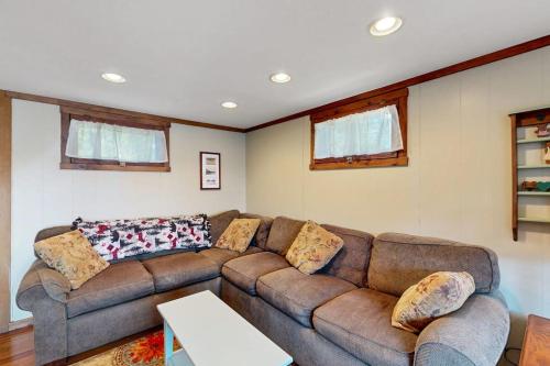 a living room with a couch and a table at Secluded lakefront cottage great views, dock & boat launch in Ellsworth