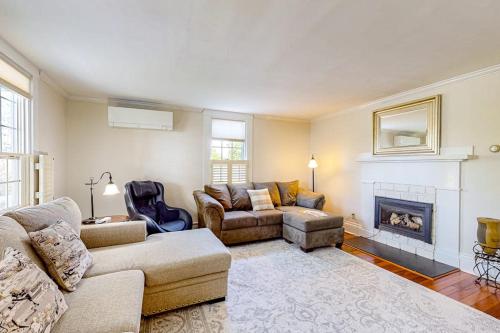 a living room with a couch and a fireplace at Classic home with prime location 1 block from Main Street in Bucksport