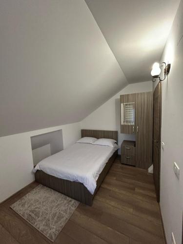 a bedroom with a bed with a white bedspread at Casa Todor Fundata in Fundăţica