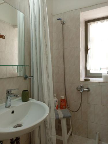 a bathroom with a sink and a shower at Feidiou 1, vol I in Egina