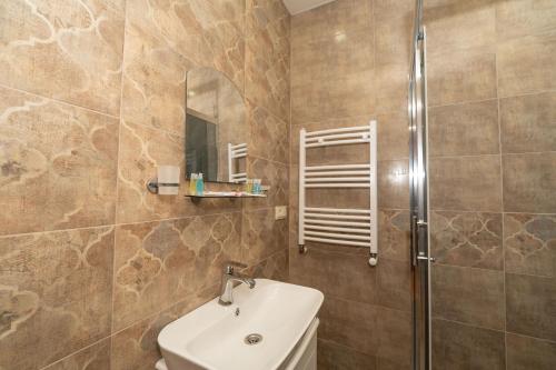 a bathroom with a toilet and a sink and a shower at Varga Kvareli in Kvareli