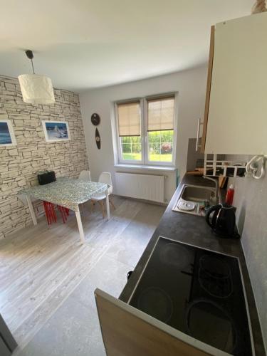 a kitchen with a sink and a counter top at House Hostelli in Grzybowo