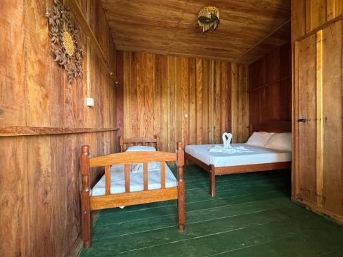 a bedroom with a bed in a wooden room at Amazon Anavilhanas Lodge in Aiparuça