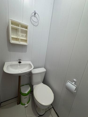 a small bathroom with a toilet and a sink at Amazon Anavilhanas Lodge in Aiparuça