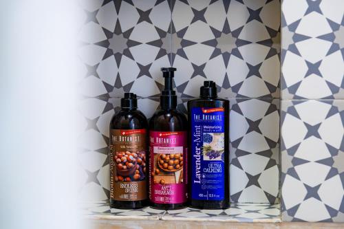 three bottles of wine sitting on a shelf at Ca Nikte Cabañas in El Cuyo