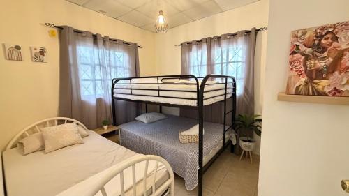 a bedroom with two bunk beds in a room at Villa azuero in Los Santos
