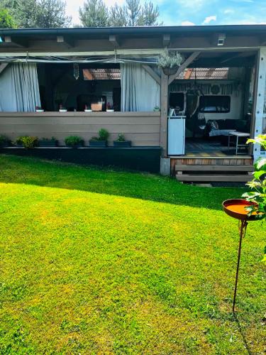 a house with a patio and a yard at Glamping Karavan u Konopiště in Chrášťany
