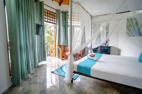 a bedroom with a bed in a room with green curtains at Castle Colombo in Piliyandala